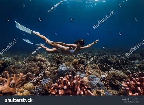 Woman Freediver Glides Fins Over Corals Stock Photo