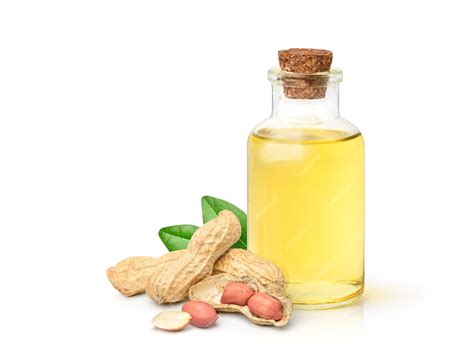 Premium Photo Peanut Oil With Peanuts And Leaves Isolated On White