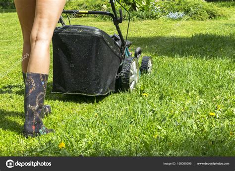 Beautiful Girl Cuts The Lawn Mowing Lawns Lawn Mower On Green Grass Mower Grass Equipment