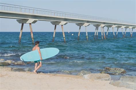 Premium Photo Shirtless Man With Surfboard At Beach