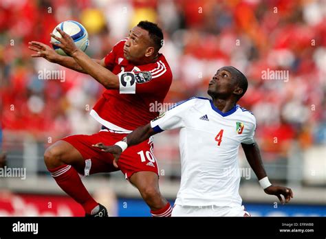 Emilio Nsue Lopez the captain of Equatorial Guinea (L) heads the ball ...