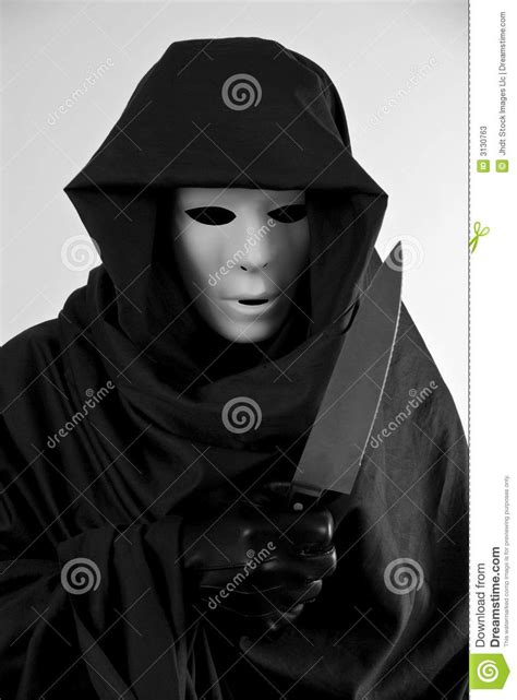 Scary Costume. A man in a scary Halloween costume holding a large ...