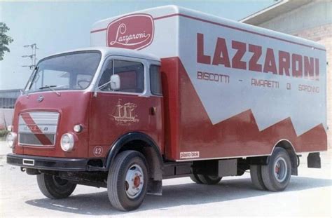 A Red And White Truck Is Parked In Front Of A Building With The Name