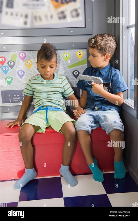 Kids playing cops and robbers at playground Stock Photo - Alamy