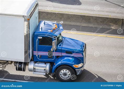 Powerful Middle Duty Day Cab Rig Semi Truck Transporting Cargo In Box Trailer Standing On The