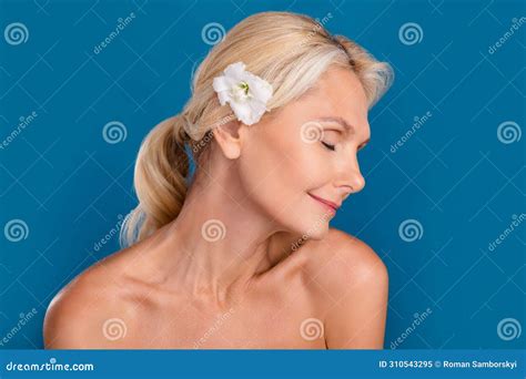 Photo Of Positive Dreamy Elderly Lady Naked Shoulders Enjoying Eustoma Flower Hairstyle Isolated