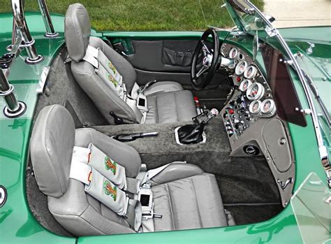 the interior of a green sports car with leather seats