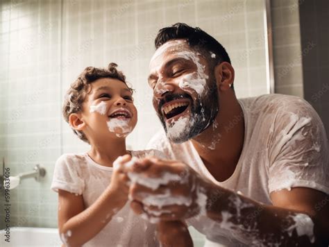 Father And Son In The Bathroom Having Fun And Shaving Foam On Their