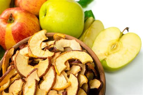 Dry Apple Slices In A Bowl And Fresh Apples On White Background