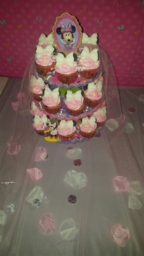 Cupcakes Are Stacked On Top Of Each Other In The Shape Of A Tower