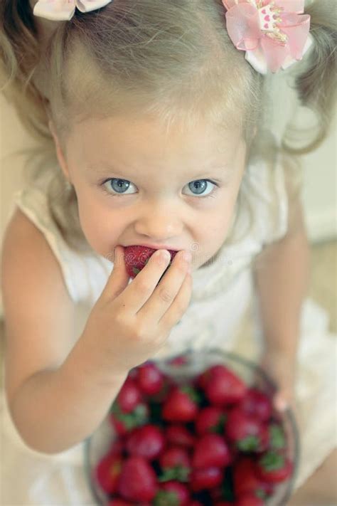 Petite Fille Blonde Mangeant La Fraise Photo Stock Image Du Vert Baie