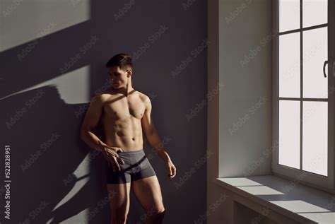 Sexy Man With Muscular Body In Black Classic Underpants Posing By