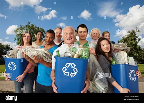 Group Of People With Recycling In Bins Stock Photo Alamy