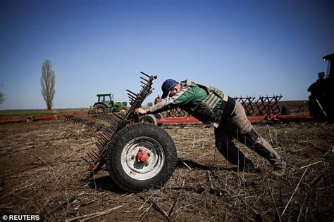 Ukrainian Farmers Don Bulletproof Vests To Plough Frontline Fields As