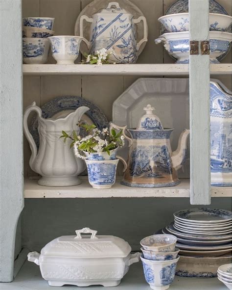 An Old China Cabinet With Blue And White Dishes On It S Shelves Filled