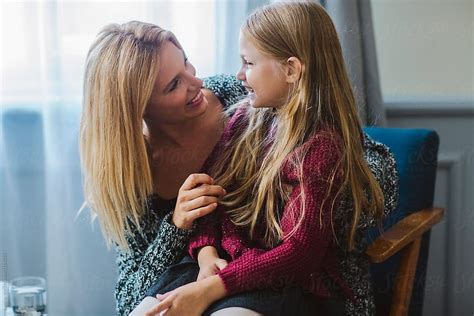 Mother Holding Her Daughter In Her Lap By Stocksy Contributor Lumina