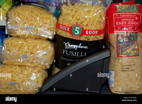 Packets Of Dried Pasta Rice On A Shelf In A Kitchen Cupboard Or Pantry