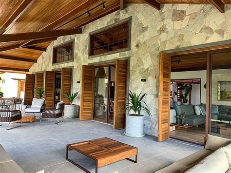 An Outdoor Living Area With Couches Tables And Chairs