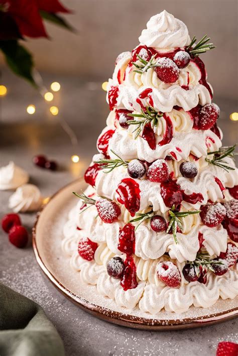 A Christmas Tree Made Out Of Meringue And Strawberries On A Platter