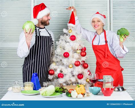 Cooking Christmas Meal Man And Woman Chef Santa Hat Near Christmas Tree Secret Ingredient Is