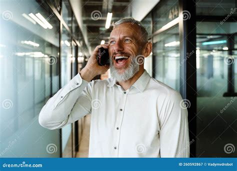 Grey Man Laughing And Talking On Cellphone While Working In Office Stock Image Image Of Talk