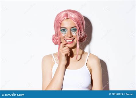 Close Up Of Coquettish Smiling Woman In Pink Party Wig Touching Lip And Looking With Temptation