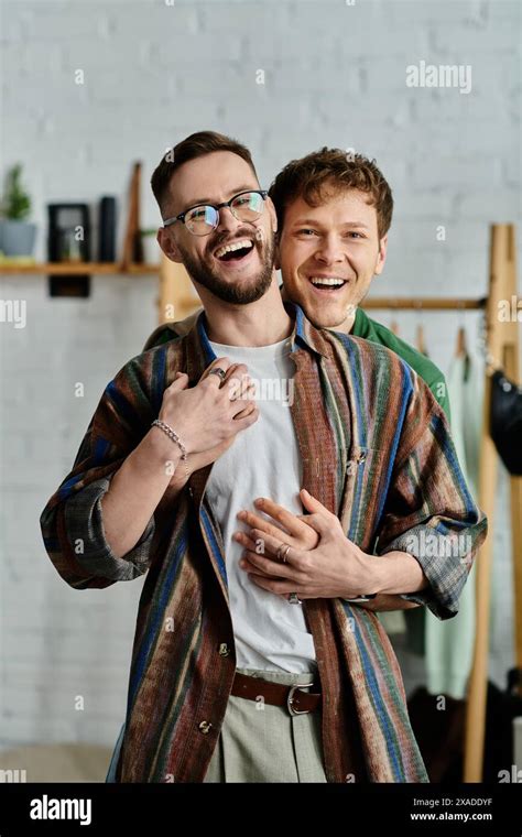 Two Men A Gay Couple Stand Side By Side In A Designer Workshop Creating Trendy Attire