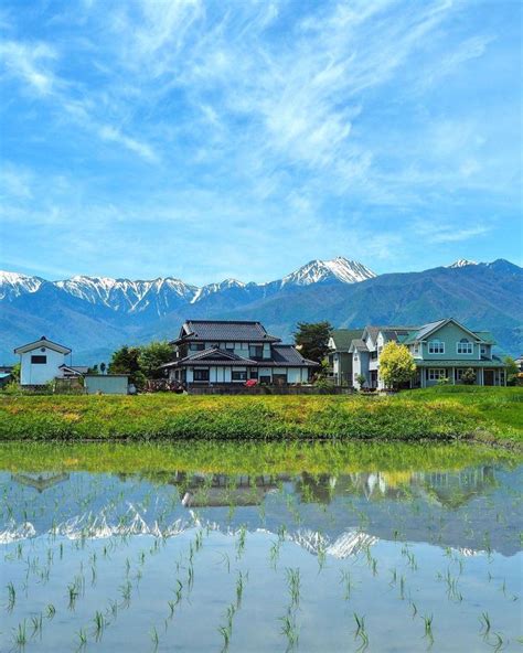 The Mountains Are Reflected In The Still Water Of This Lake While