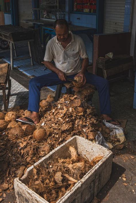 A Man Is Peeling The Coconut Fruit With Machete Editorial Stock Photo