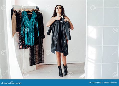 Beautiful Brunette Woman Tries Dressing Room Wardrobe Stock Image