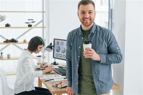 Premium Photo Positive Man Standing In Front Of Woman That Sitting By