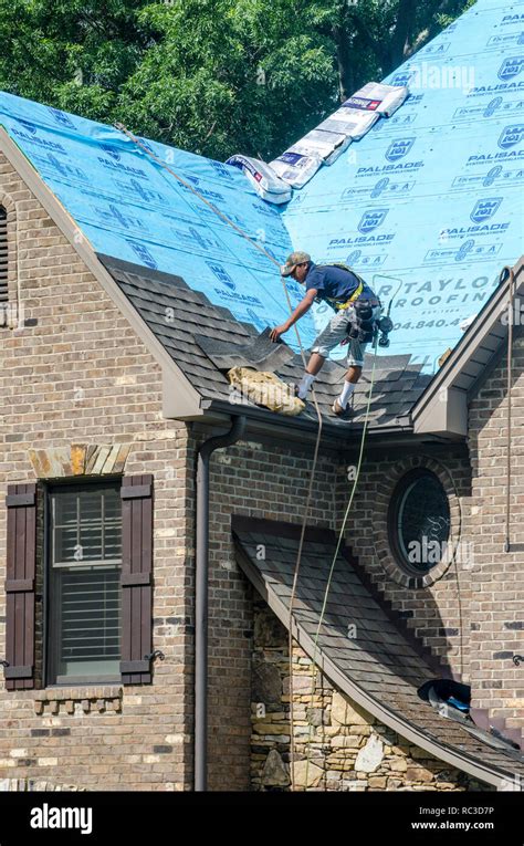 Roofing Contractors Replacing Damaged Roofs After A Hail Storm Stock