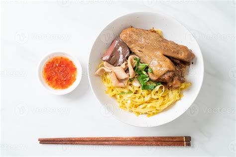 Egg noodles served dry with braised duck 11524130 Stock Photo at Vecteezy