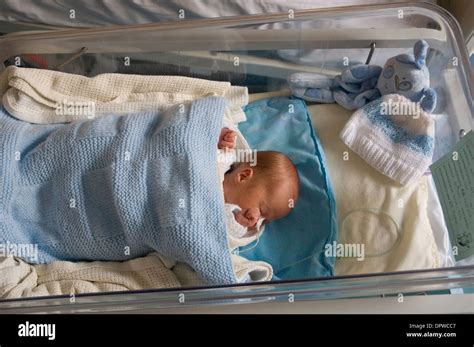 Premature Newborn Baby Boy In Hospital Cot With A Feeding Tube Attached