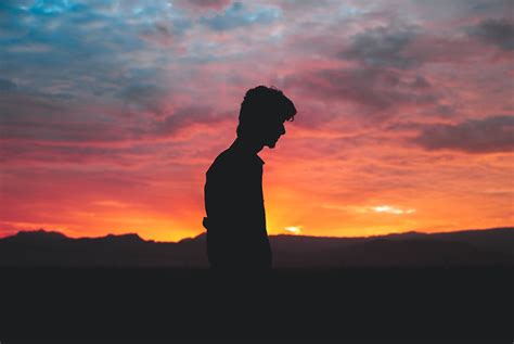 Silhouette of Man Standing during Sunset · Free Stock Photo