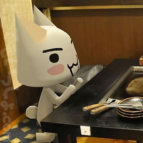 A Paper Cat Sitting On Top Of A Table Next To A Plate And Knifes