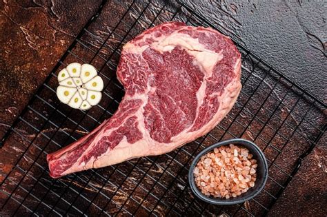 Premium Photo Raw Uncooked Dry Aged Beef Tomahawk Or Rib Eye Steak