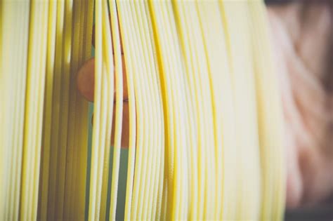 Premium Photo Close Up Of Hand Checking Spaghetti Drying In Factory