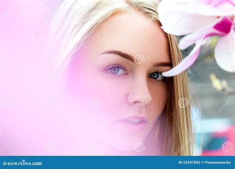 Seductive Blonde Female With Blue Eyes In Blooming Pink Flowers Stock Photo Image Of Caucasian