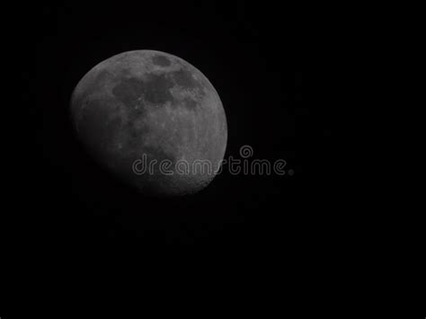 Closeup Of The Half Moon Shining In A Dark Night Sky Stock Photo