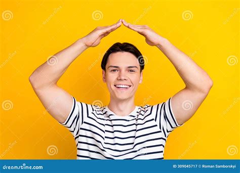 Photo Of Funny Positive Guy With Brunet Hair Dressed Striped T Shirt Palms Make Roof Over Head