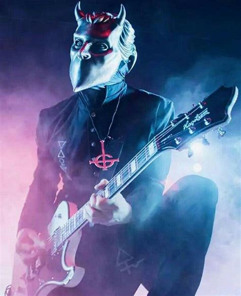 A Man In A Mask Playing An Electric Guitar