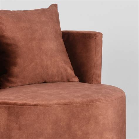 A Large Brown Chair With Two Pillows On It S Back And The Seat Upholstered