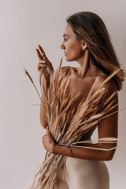 Premium Photo Half Naked Woman Covers Herself With Dry Ears Of Corn