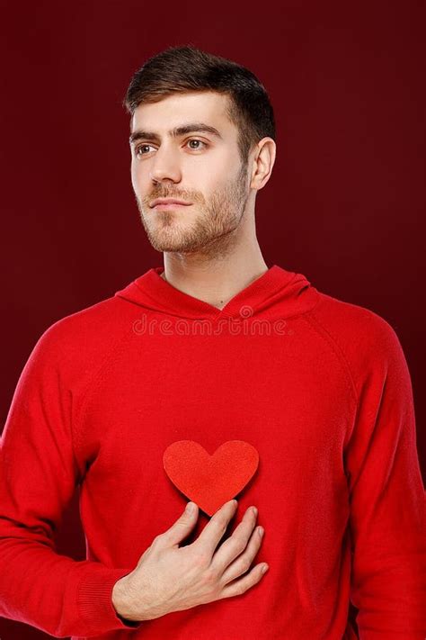 Young Handsome Man With A Red Heart In His Hands On Valentine Day Stock