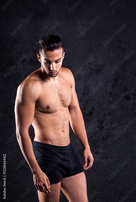 Sexy Shirtless Male Model Flirting Against Black Background Stock Foto