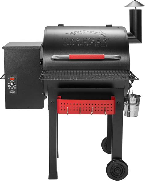 A Black Grill With Red Trimmings On The Side And An Open Door To It