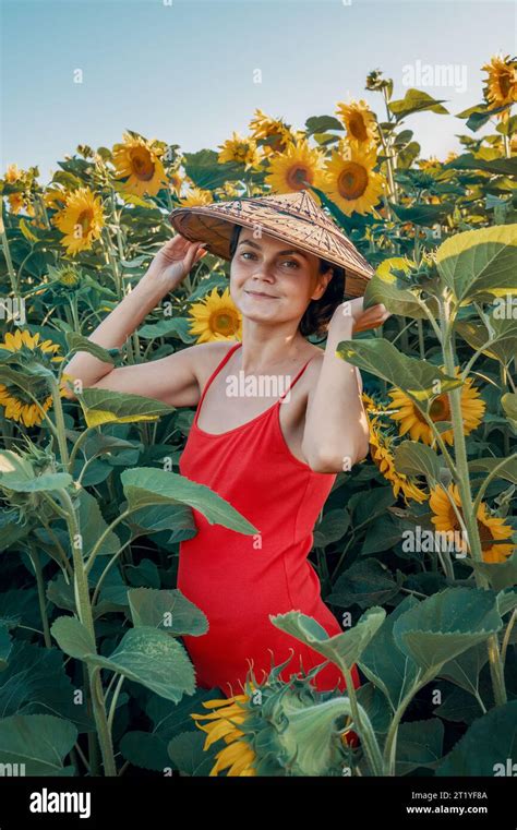 Beautiful Caucasian Woman In Sunflowers Portrait Of A Woman Wearing A