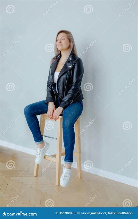 A Blonde Woman In A Black Leather Jacket Is Sitting Stock Image Image