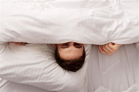 Man Hiding In Bed Under Sheets Stock Photo By ©piotrmarcinski 70526599